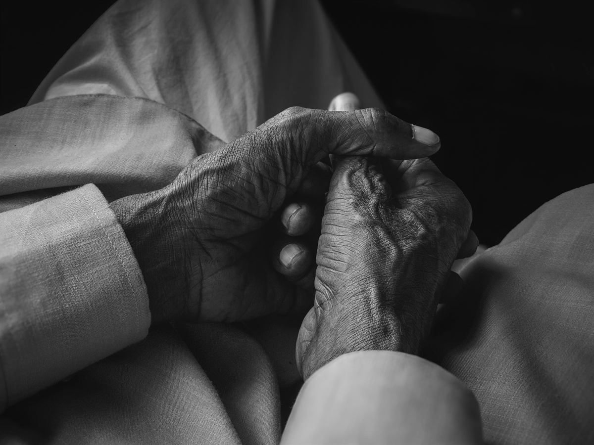 Close-up of an elderly person's weathered hands